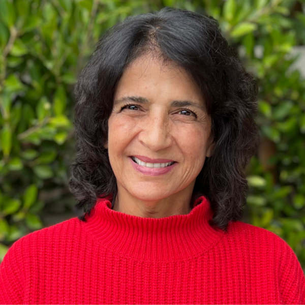Headshot of women smiling, wearing a red sweater