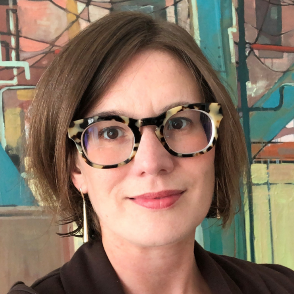 Headshot of women with fun glasses smiling