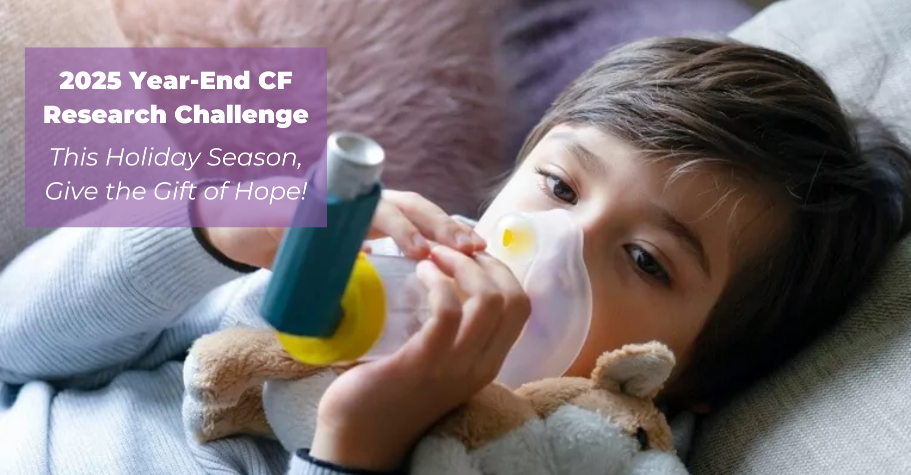 Young boy laying down with a stuffed animal, and he is using an inhaler